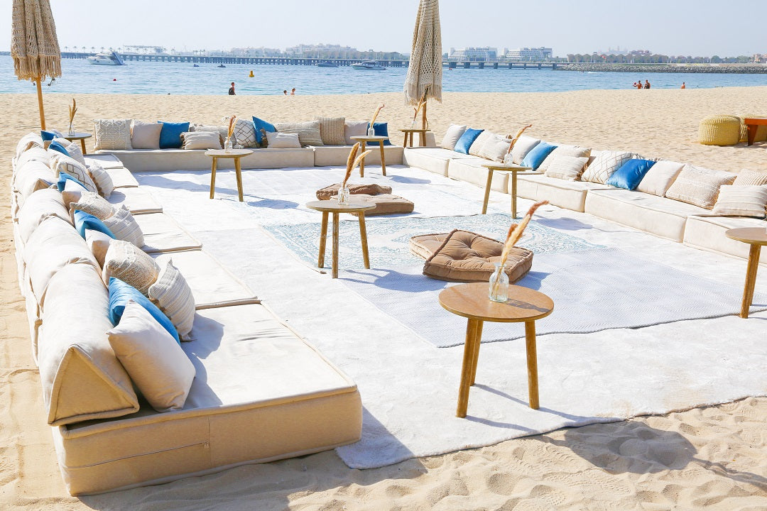 Spacious and modern lounge low seating arrangement featuring plush cushions and a sleek, low-profile design. The seating area includes a combination of modular pieces with soft upholstery in a neutral color palette, ideal for creating a comfortable and stylish relaxation space in contemporary living areas