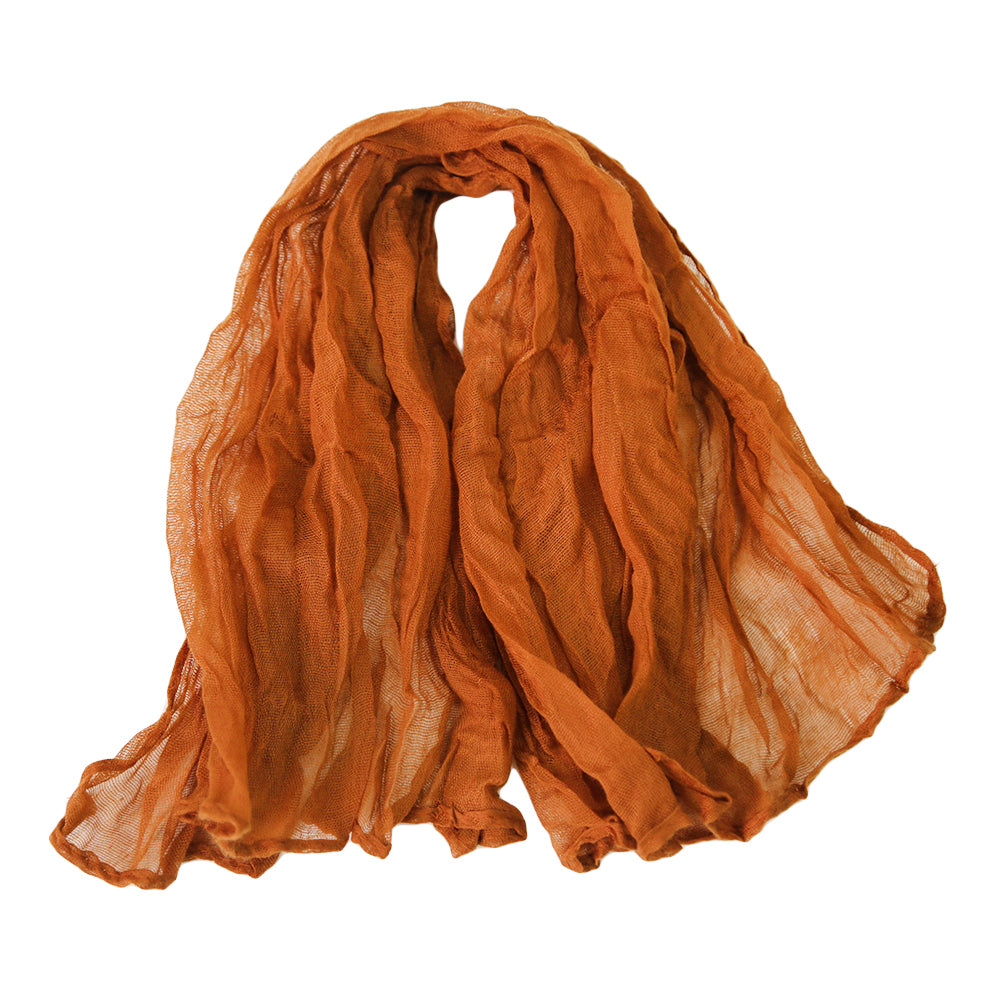 A gauze napkin in burnt orange, made from soft cotton fabric. The vibrant burnt orange color adds a warm and lively touch to table settings, perfect for creating a bold and inviting atmosphere.