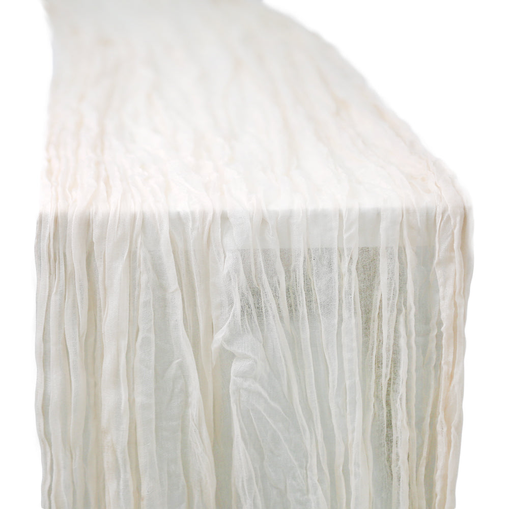 A gauze table runner in off white, featuring a soft and airy fabric. The subtle off white color adds a gentle and sophisticated touch to any table setting, perfect for creating a light and elegant ambiance.