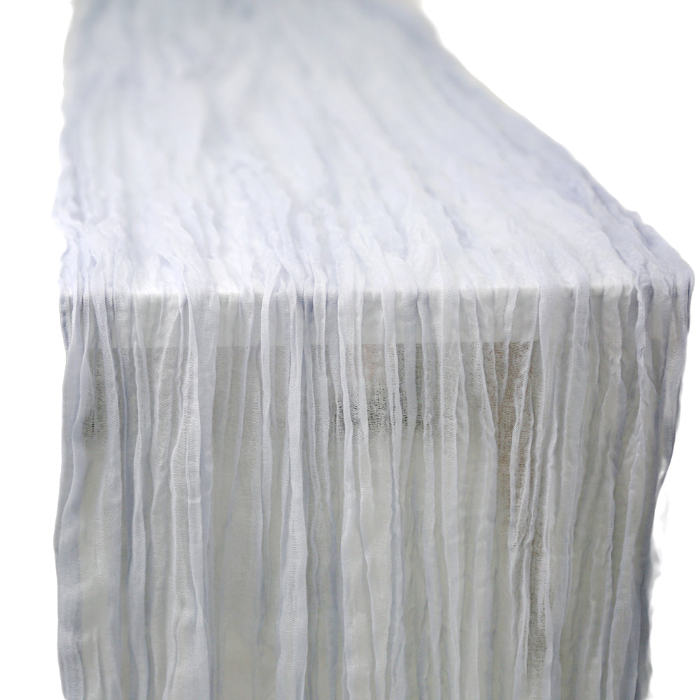 A gauze table runner in sand, featuring a soft and airy fabric. The warm sand color adds a subtle and elegant touch to any table setting, perfect for creating a relaxed and sophisticated ambiance.