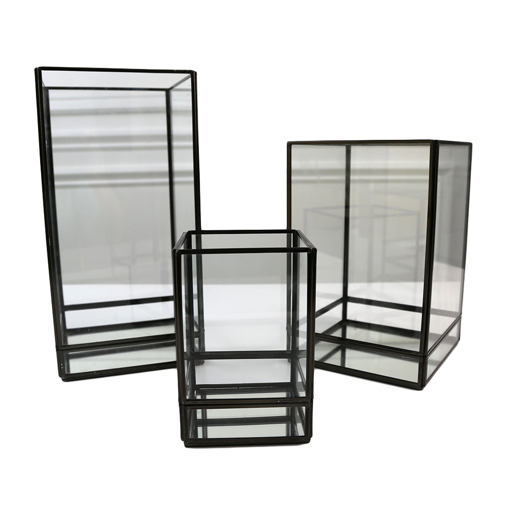 Modern Black Edge Lanterns, featuring a sleek and contemporary design in black. These lanterns add a stylish and sophisticated touch to any space, ideal for enhancing the ambiance of both indoor and outdoor settings with their modern edge and elegant appearance.