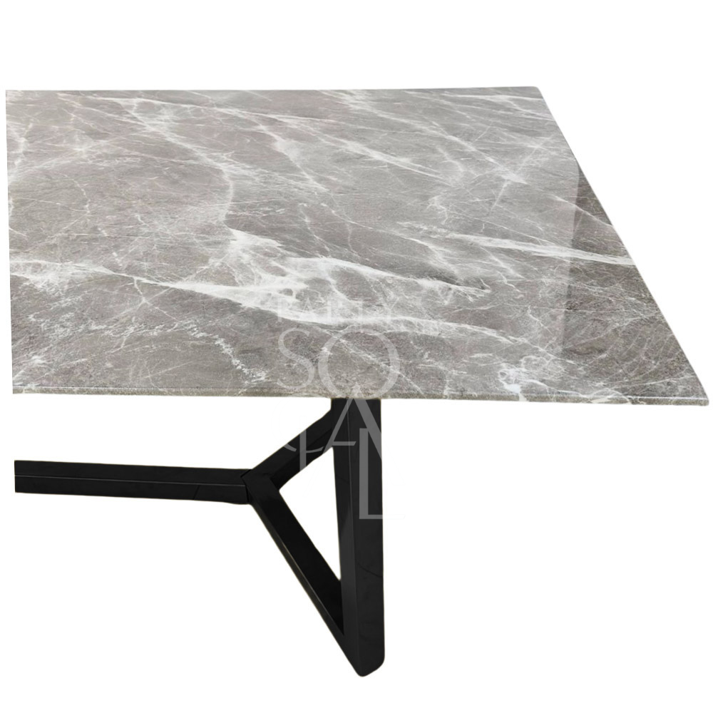 A table with a black base and a grey marble top, featuring a sleek and modern design. The black steel base provides a sturdy foundation, while the grey marble top adds a touch of elegance and sophistication. This stylish table enhances any decor with its refined and contemporary look.