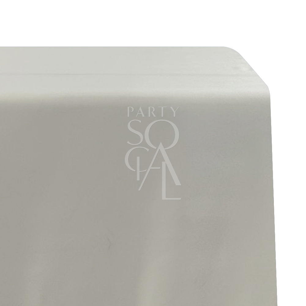 A rectangular satin tablecloth in soft cream, with a luxurious and shiny texture. This refined tablecloth adds warmth and elegance to your dining area, ideal for both casual and formal gatherings.