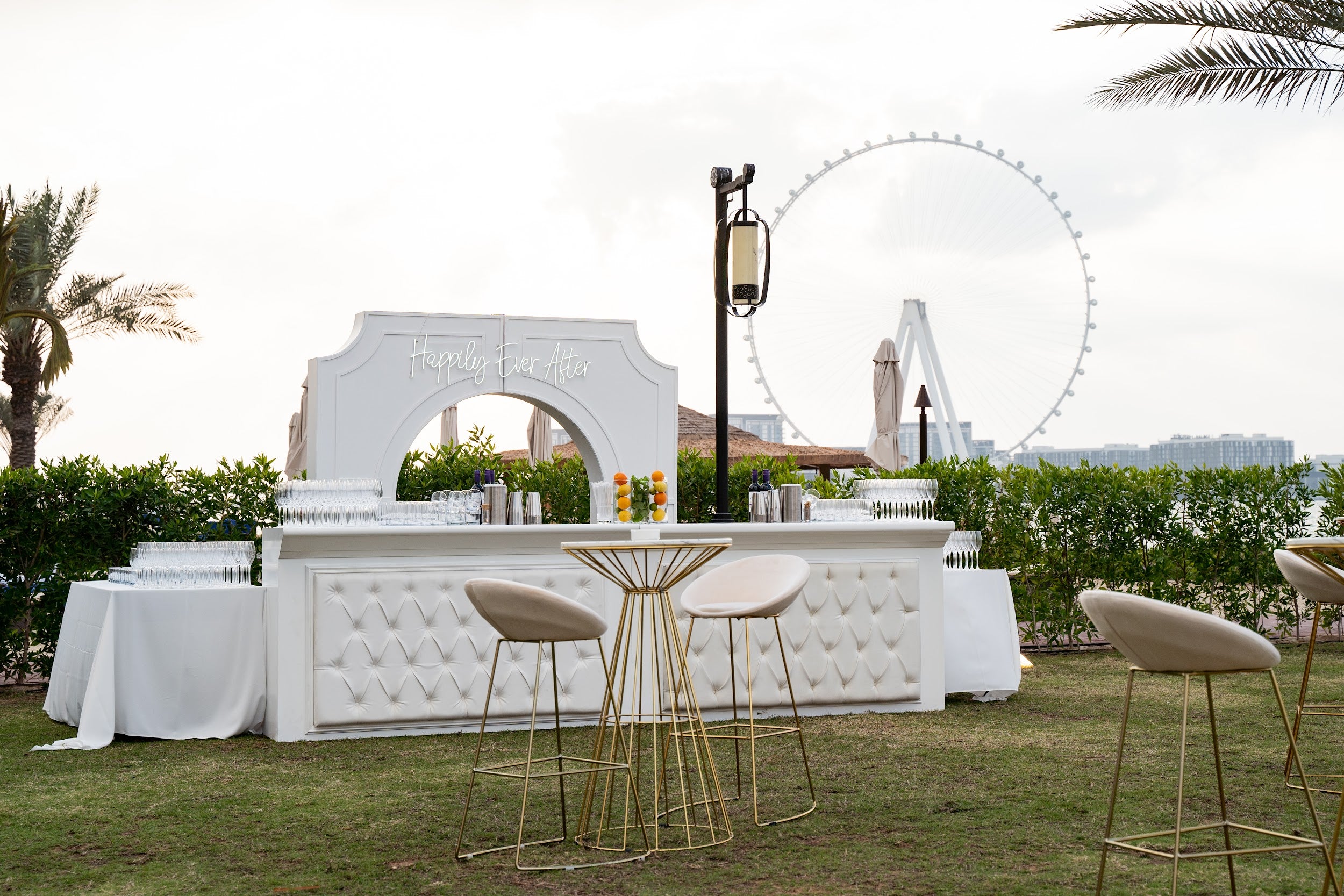 Cream and gold base bar stool featuring a chic and elegant design. The stool is upholstered in soft cream fabric, complemented by a striking gold base that adds a touch of luxury. Its modern design and high-quality materials make it a stylish addition to any bar or counter area, blending sophistication with functionality.