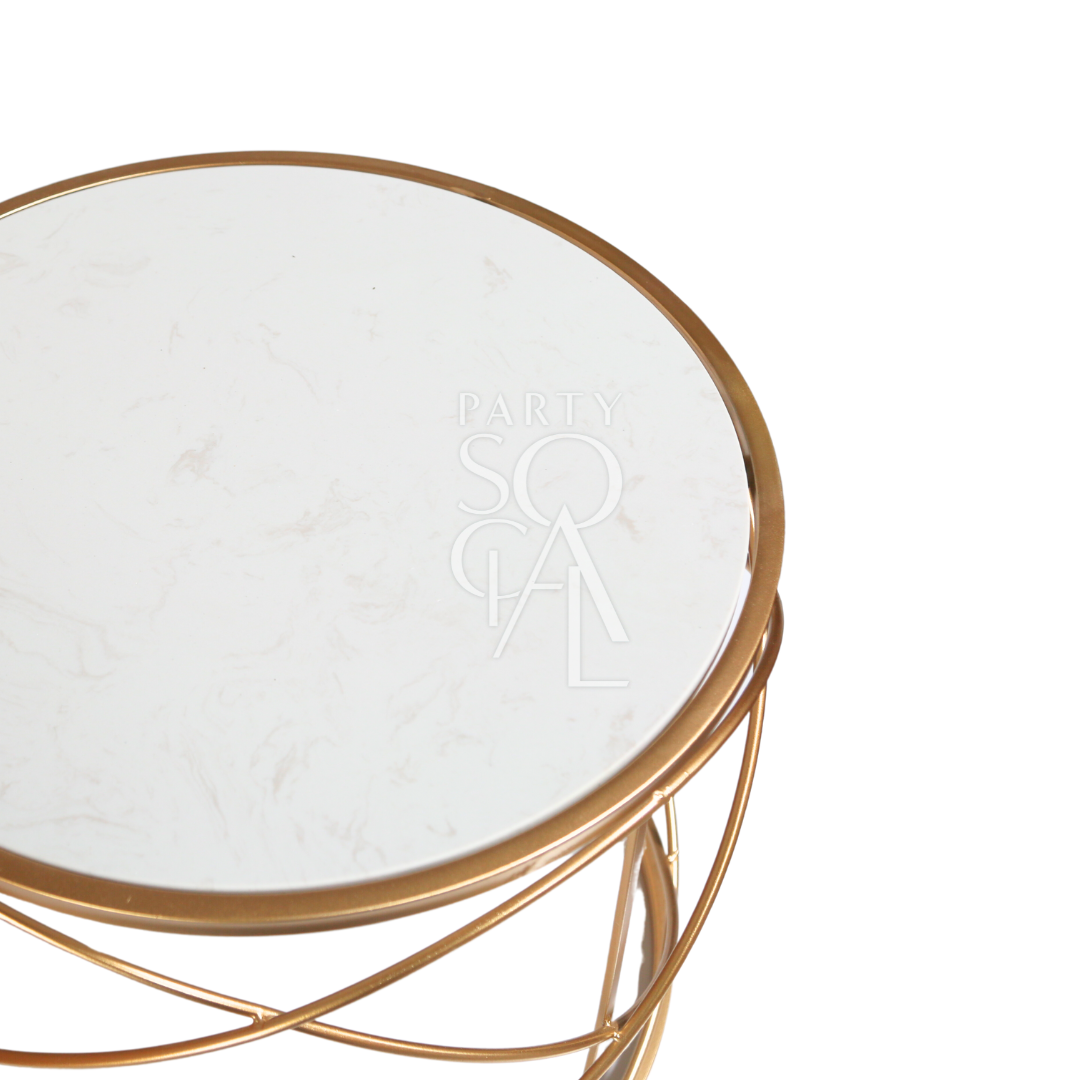 A gold wire coffee table with a marble top featuring a chic and modern design. This stylish table boasts a luxurious marble surface paired with an elegant gold wireframe, creating a striking centerpiece for any living room or lounge. Perfect for adding a touch of sophistication and contemporary flair to your space while providing a functional surface for drinks, decor, and more.