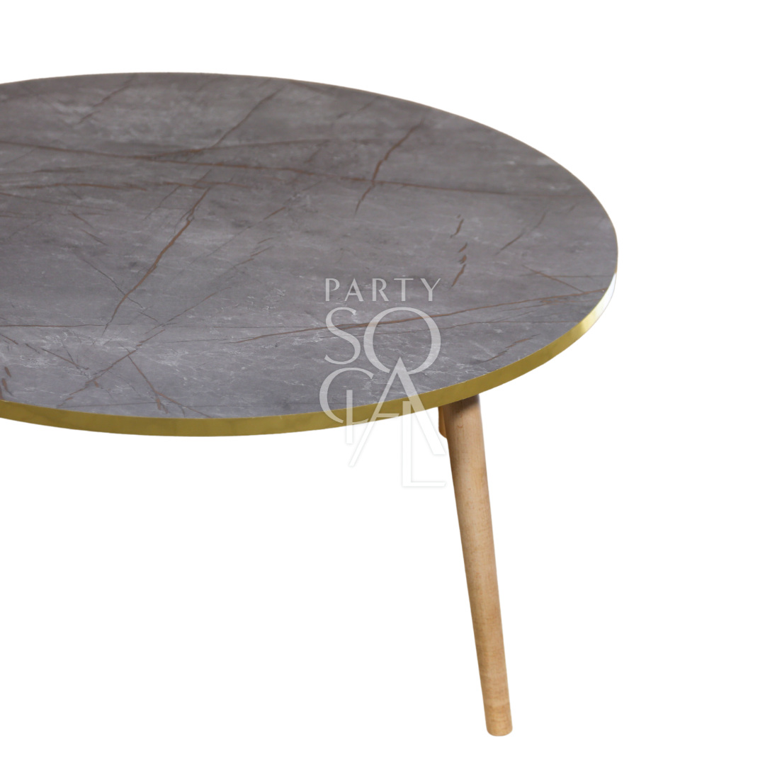 A grey gold-rimmed coffee table featuring a modern and elegant design. This stylish table has a sleek grey surface complemented by a luxurious gold rim, adding a touch of sophistication to any room. Perfect for living rooms, lounges, or offices, it combines functionality with contemporary flair, ideal for displaying decor items or serving drinks and snacks.