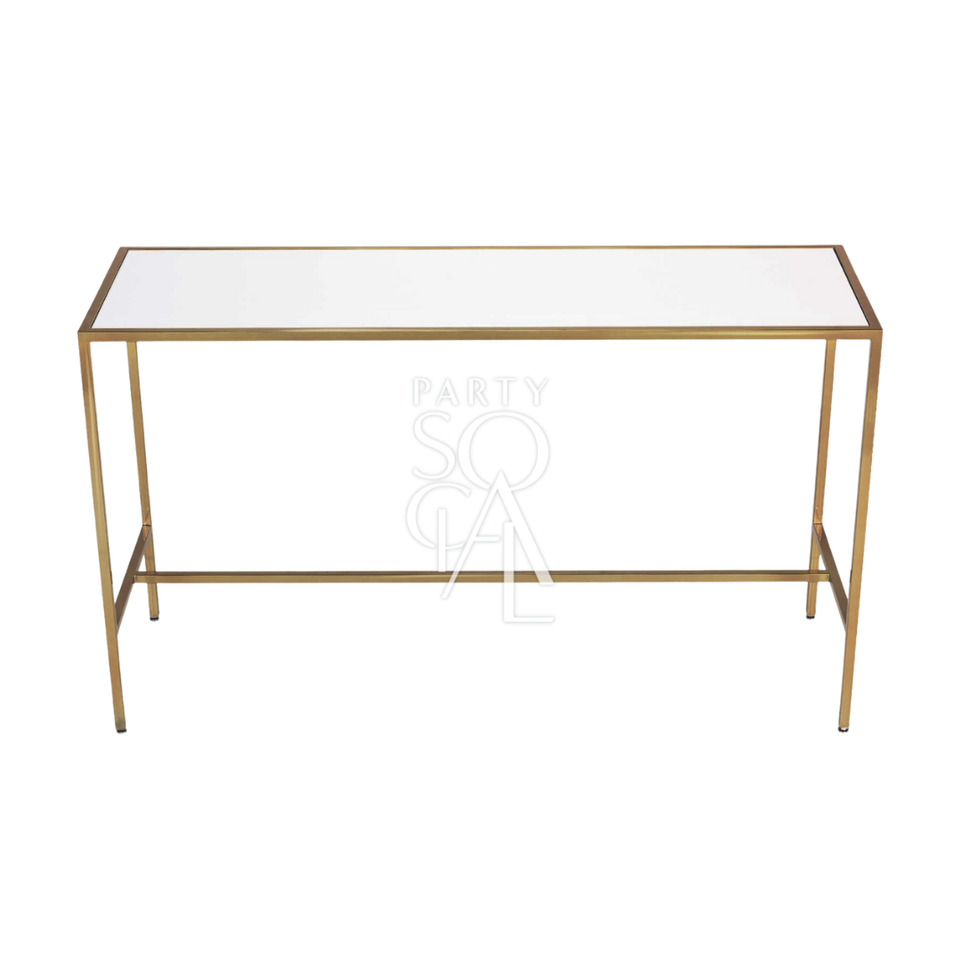 A high glass rectangular table with a gold base, featuring a sleek and modern design with a clear glass tabletop and a sturdy gold-finished base. The combination of transparent glass and luxurious gold provides a sophisticated and contemporary look, perfect for dining rooms, conference rooms, or stylish event settings.