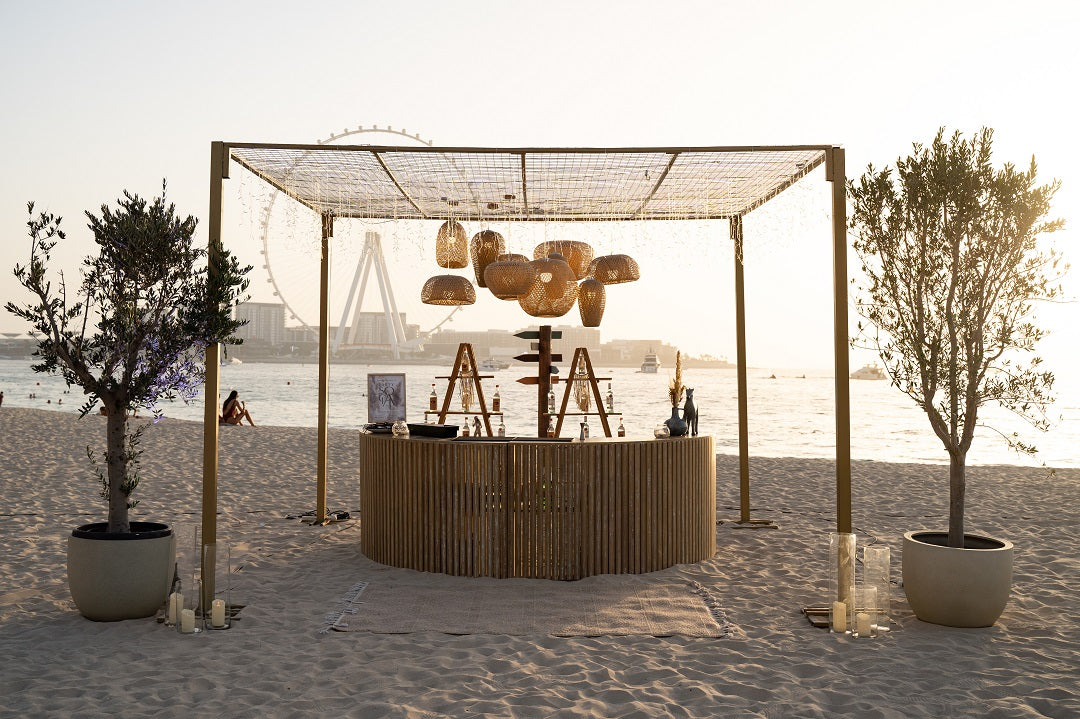 A semi wooden bar unit featuring a blend of wood and modern materials. This stylish bar unit combines natural wooden elements with contemporary design, creating a sophisticated and versatile addition to any bar or event space. Perfect for serving drinks and entertaining guests, it adds a warm and elegant touch to any setting.