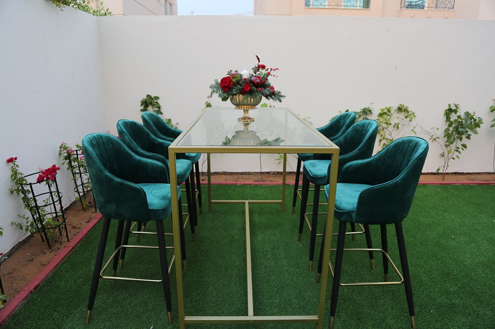 A high glass rectangular table with a gold base, featuring a sleek and modern design with a clear glass tabletop and a sturdy gold-finished base. The combination of transparent glass and luxurious gold provides a sophisticated and contemporary look, perfect for dining rooms, conference rooms, or stylish event settings.
