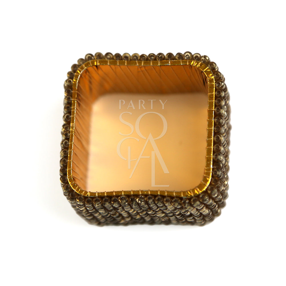 A gold beaded napkin ring featuring a stylish and elegant design. This napkin ring is adorned with small, gleaming gold beads arranged in a sophisticated pattern, adding a touch of luxury and refinement to your table setting. Ideal for enhancing the presentation of napkins at formal dinners, special occasions, or elegant gatherings.
