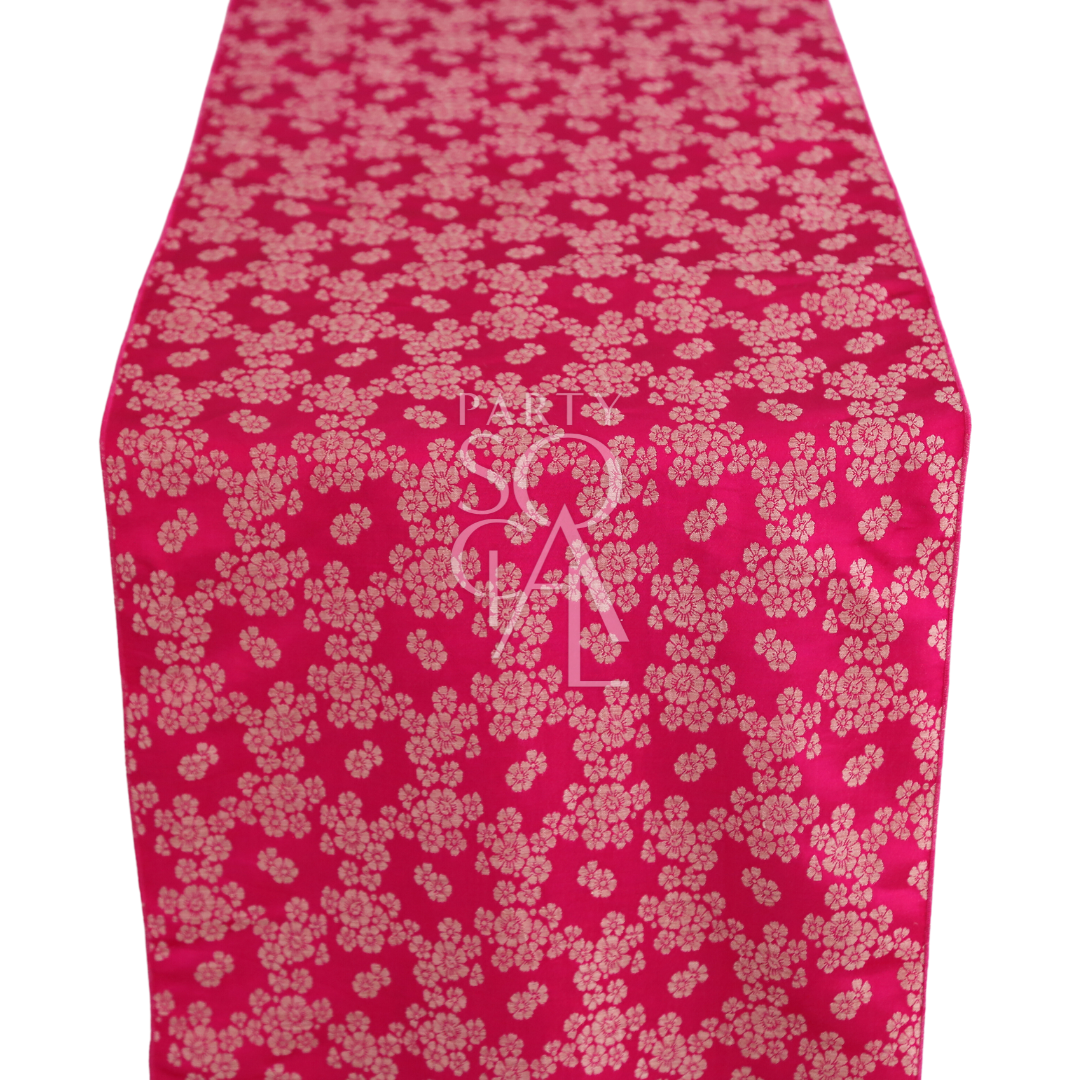 A cushion cover in vibrant fuchsia brocade, showcasing an ornate pattern with rich textures and sophisticated design. Ideal for adding a bold and stylish accent to any living space or bedroom.