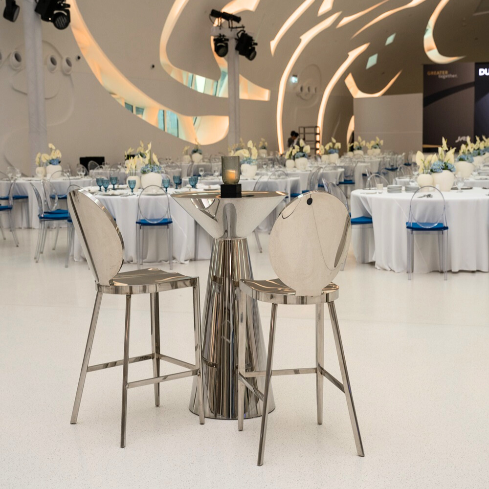 Bar stool with mirrored silver design, elegant event seating, chic silver bar chair, reflective surface stool, stylish party furniture, sophisticated bar stool for events, modern mirrored bar chair.