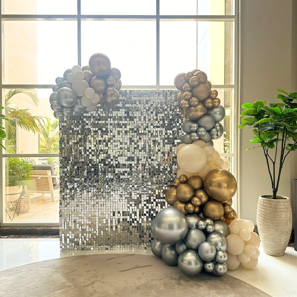 A mini sequin wall balloon backdrop in silver, featuring a shimmering and reflective design. The silver sequins add a glamorous and sparkling touch, while the balloons enhance the festive and elegant appearance. This backdrop creates a dazzling and stylish setting for events and special occasions.