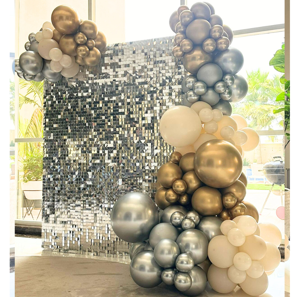A mini sequin wall balloon backdrop in silver, featuring a shimmering and reflective design. The silver sequins add a glamorous and sparkling touch, while the balloons enhance the festive and elegant appearance. This backdrop creates a dazzling and stylish setting for events and special occasions.
