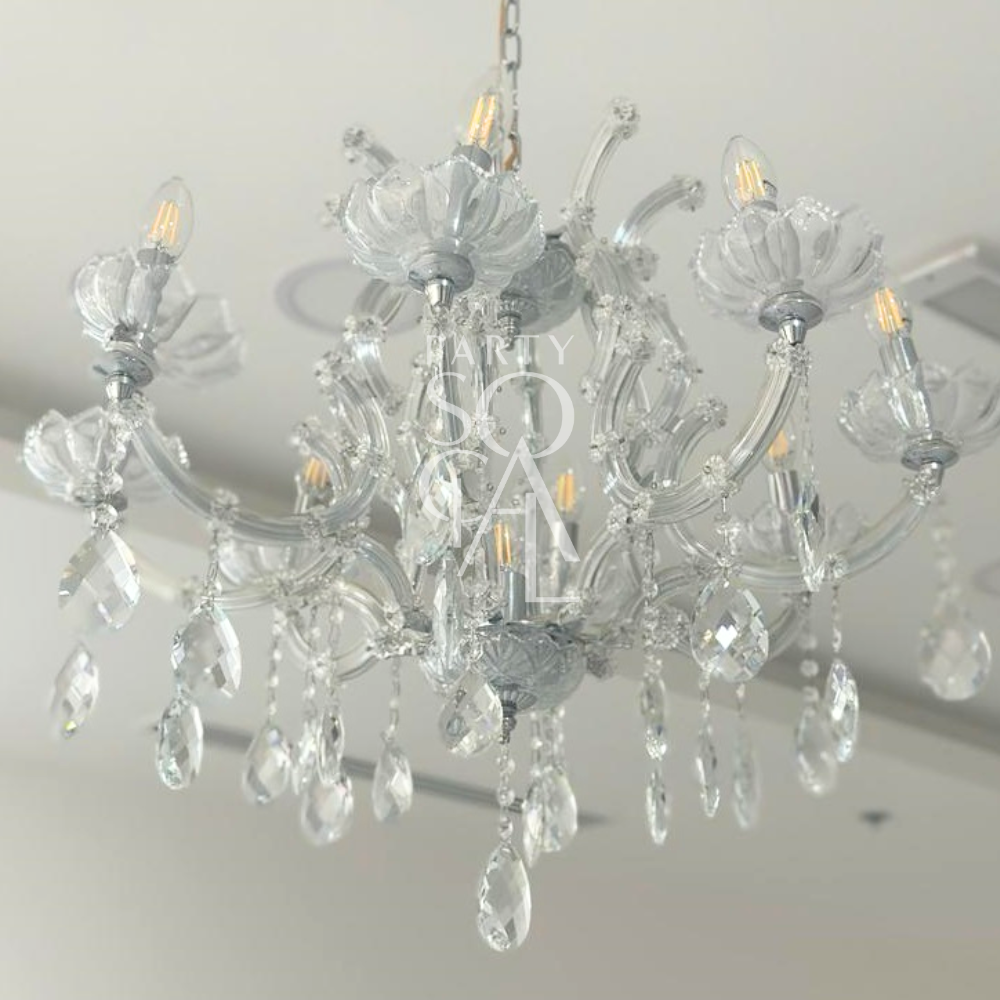Exquisite crystal chandelier featuring a dazzling array of crystal droplets and intricate metalwork. The chandelier’s sparkling crystals reflect light beautifully, creating a luxurious and elegant ambiance. Ideal for adding a touch of glamour and sophistication to any grand space or formal setting.