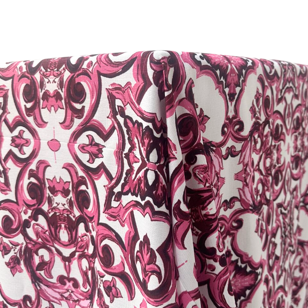 Rectangular Majolica tablecloth in a soft pink hue, featuring intricate patterns inspired by traditional Majolica designs. Ideal for adding a touch of elegance to any dining setup.
