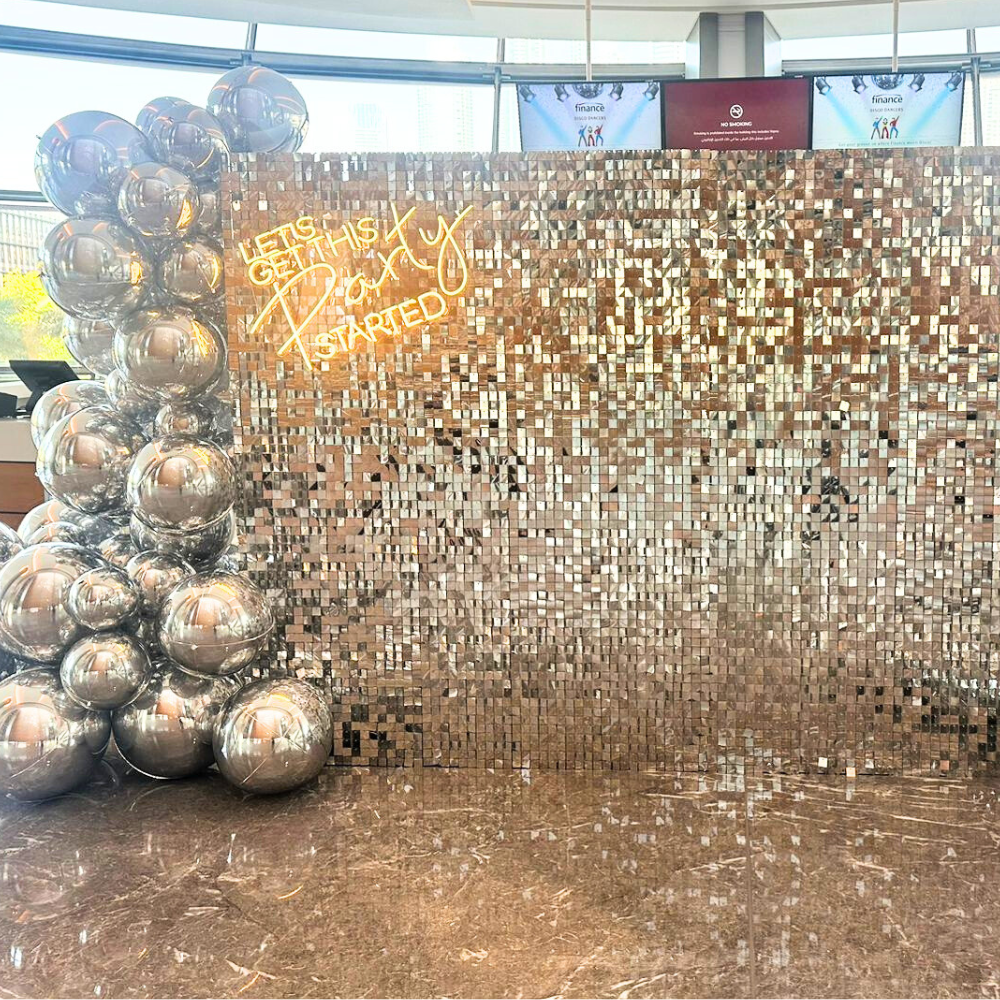 A sequin wall in gold and silver, featuring a dazzling and elegant design. The shimmering sequins in gold and silver create a luxurious and eye-catching backdrop, perfect for adding a glamorous touch to events, parties, and photo shoots.