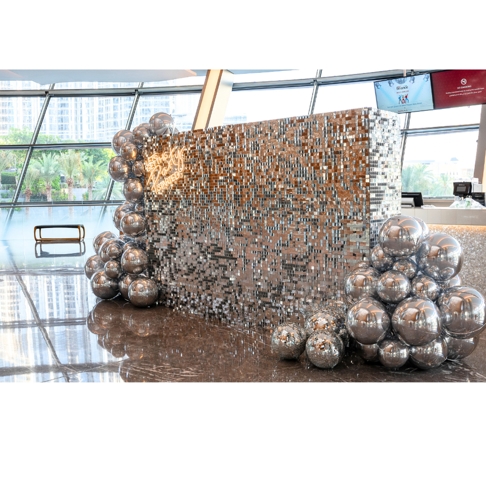 A silver sequin wall balloon backdrop in silver, featuring a dazzling and elegant design. This backdrop adds a luxurious and festive touch to events, parties, and photo shoots, creating a stunning visual centerpiece.