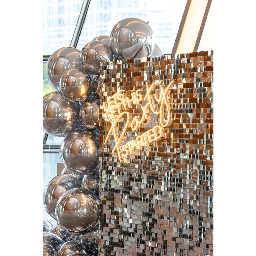 A silver sequin wall balloon backdrop in silver, featuring a dazzling and elegant design. This backdrop adds a luxurious and festive touch to events, parties, and photo shoots, creating a stunning visual centerpiece.