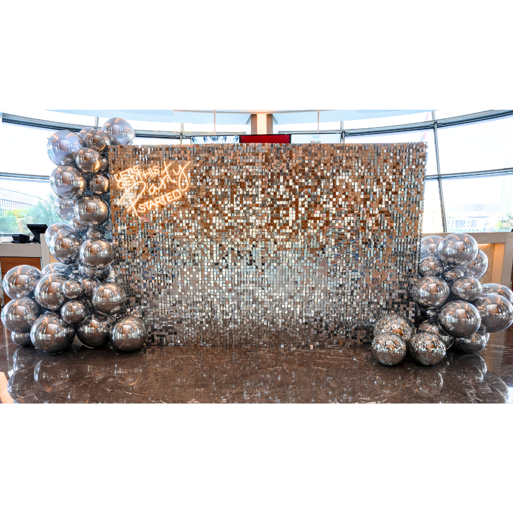A silver sequin wall balloon backdrop in silver, featuring a dazzling and elegant design. This backdrop adds a luxurious and festive touch to events, parties, and photo shoots, creating a stunning visual centerpiece.