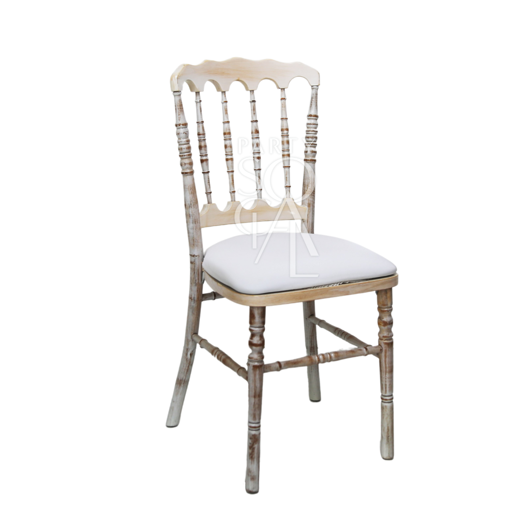Napoleon creamwash chair featuring a classic design with a soft cream finish. This elegant chair combines traditional styling with a contemporary wash effect, making it a stylish addition to formal dining rooms, event spaces, or home interiors. The neutral color and sophisticated design ensure it complements a wide range of decor styles.