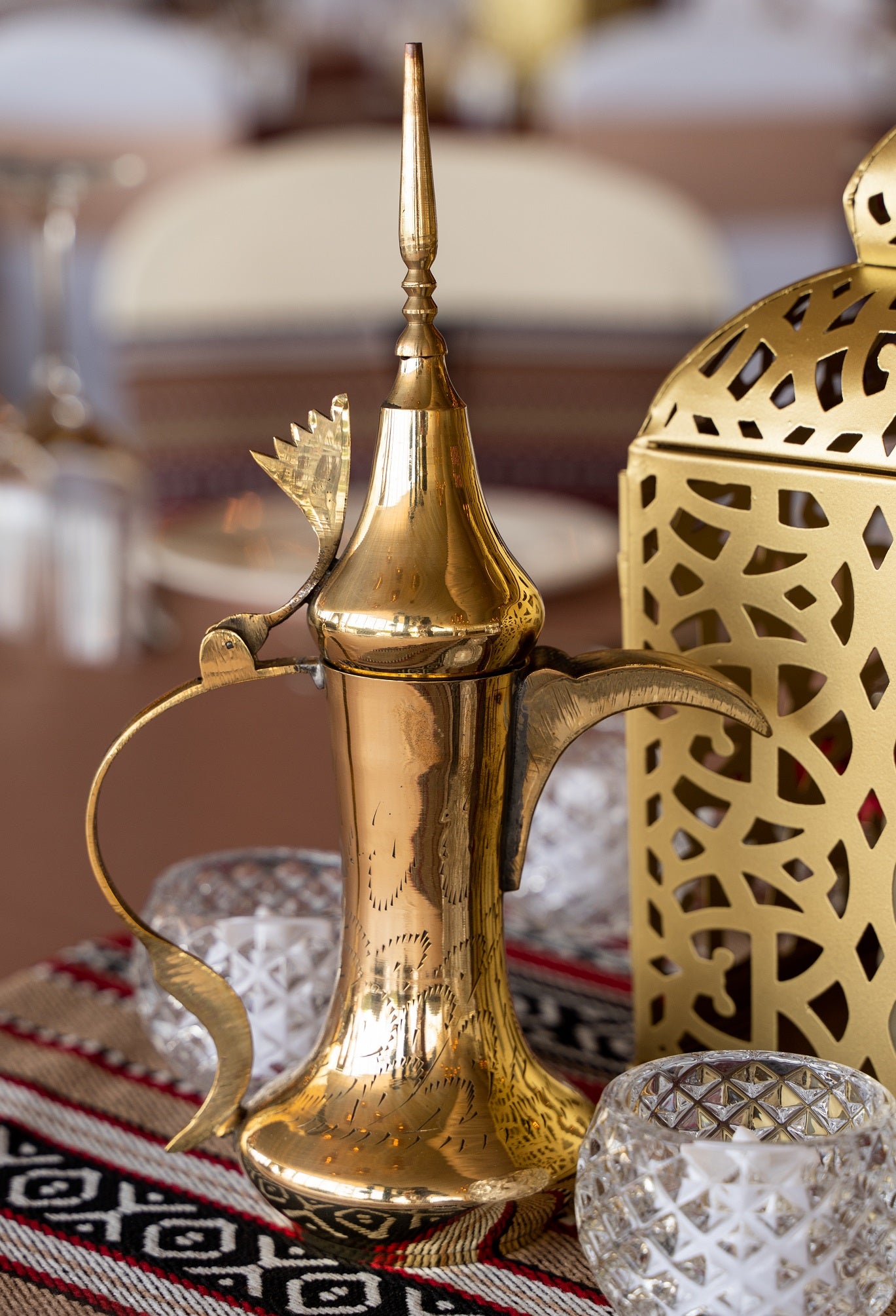 Traditional Dallah Arabic coffee pot, featuring an elegantly curved spout and handle with intricate detailing. The pot is designed with a classic, ornate shape and a polished finish, making it a stylish and functional piece for serving Arabic coffee.