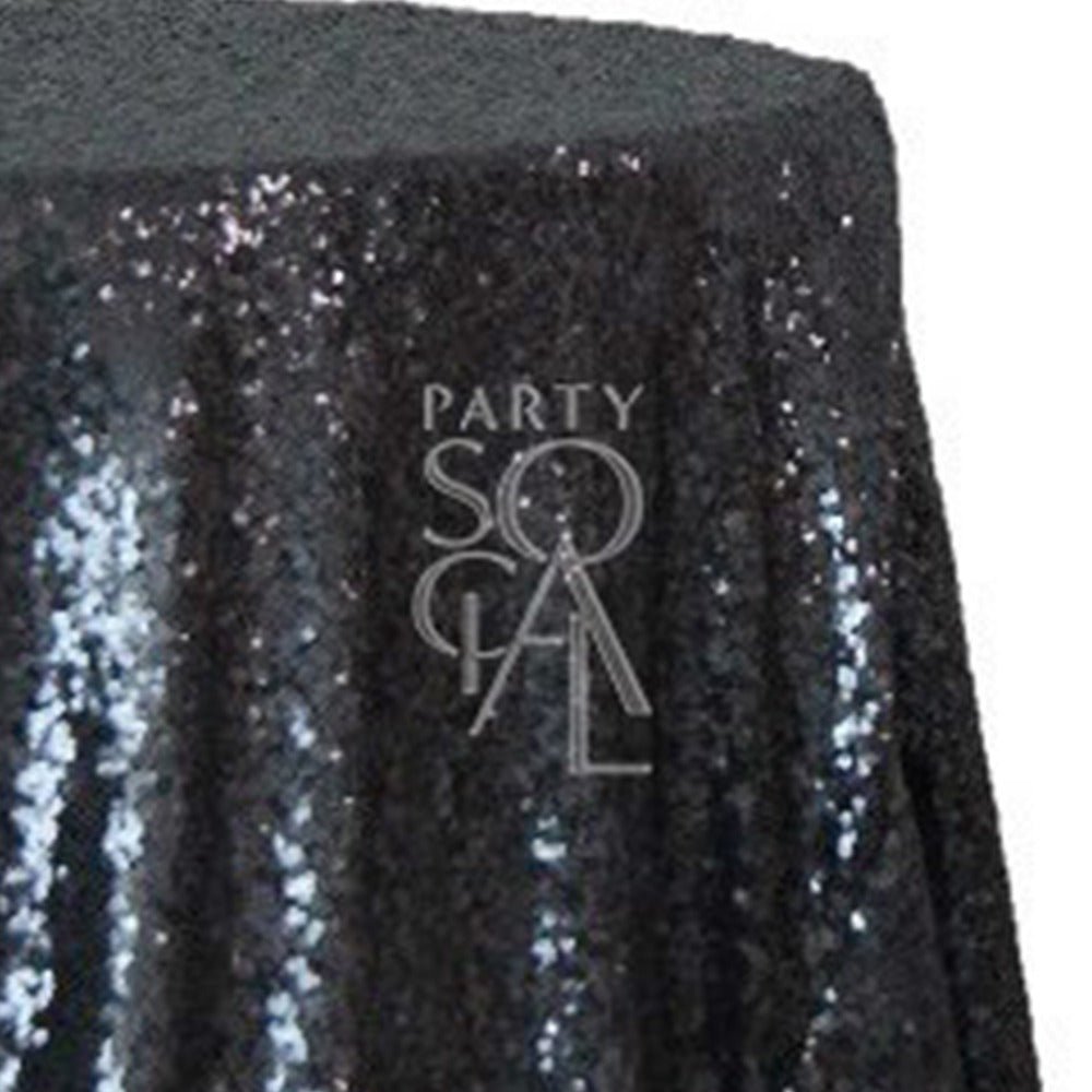 Round sequin tablecloth in sleek black, showcasing a dramatic and elegant shimmer. The black sequins create a chic and sophisticated look, perfect for adding a touch of luxury and refinement to any event.