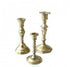 Set of three brass candlesticks, each with a classic, polished finish and designed to hold taper candles, perfect for adding a touch of elegance and warmth to any table or mantel.