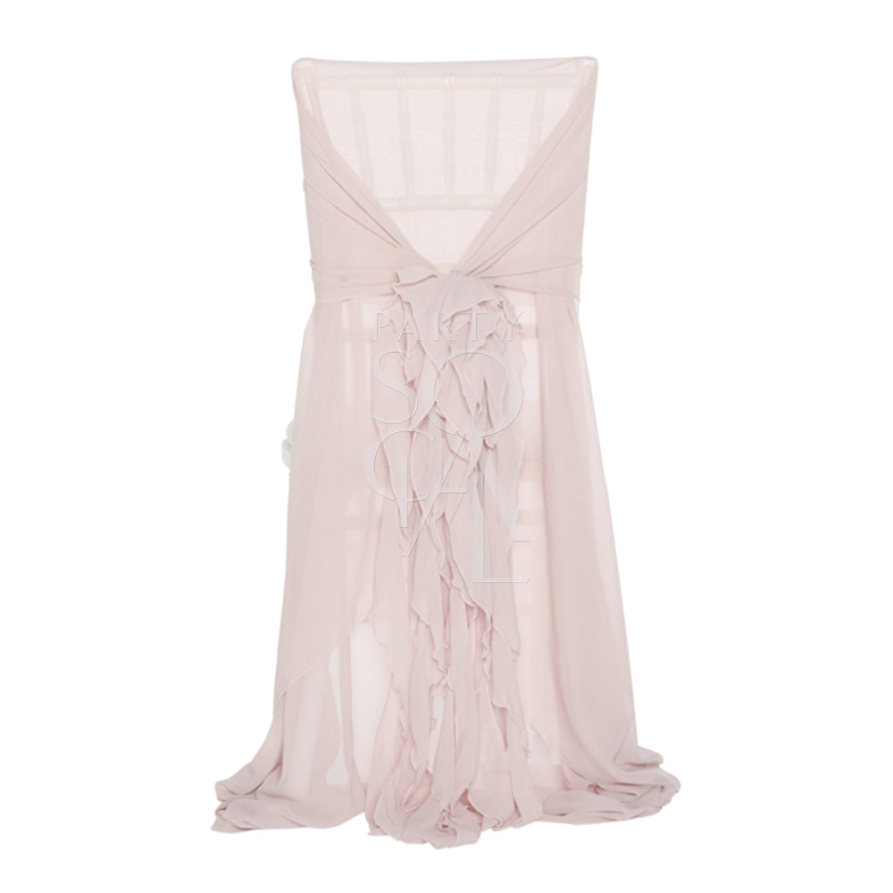 Elegant Chiavari chair cover in a soft blush pink color, featuring delicate ruffled detailing cascading down the back. The luxurious ruffles add a romantic and sophisticated touch, making it perfect for weddings, special events, or upscale gatherings, transforming any chair into a statement piece.