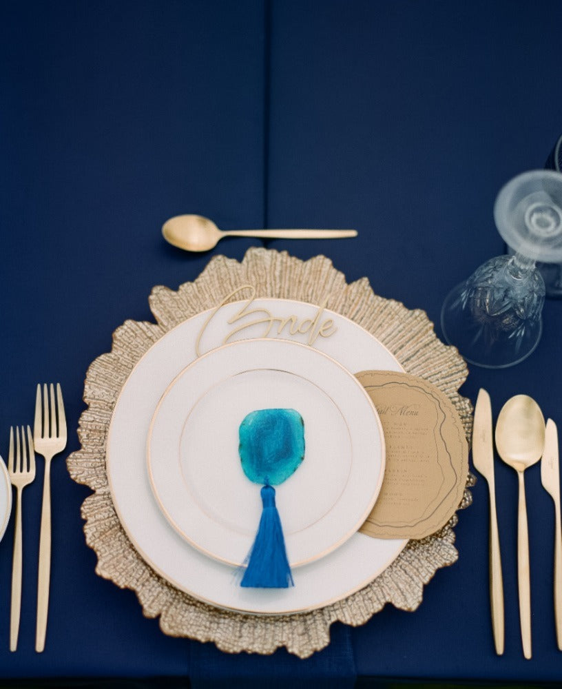 Charger plate with a gold starburst design, showcasing a dynamic pattern of radiating lines that create a vibrant and eye-catching effect on your table setting.