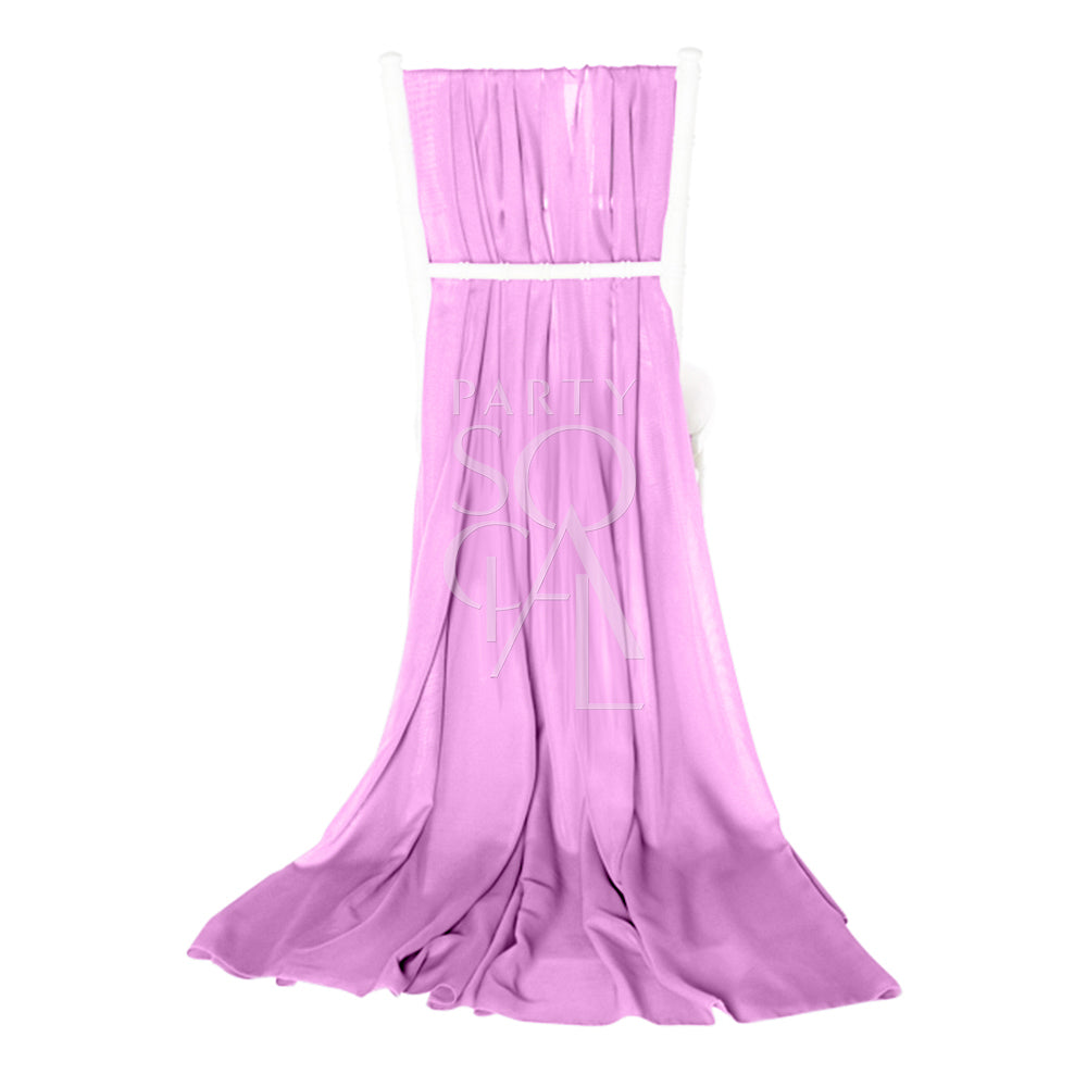 Delicate lilac chiffon chair cover with a train for Chiavari chairs. The soft lilac hue and flowing chiffon create a charming, whimsical look.