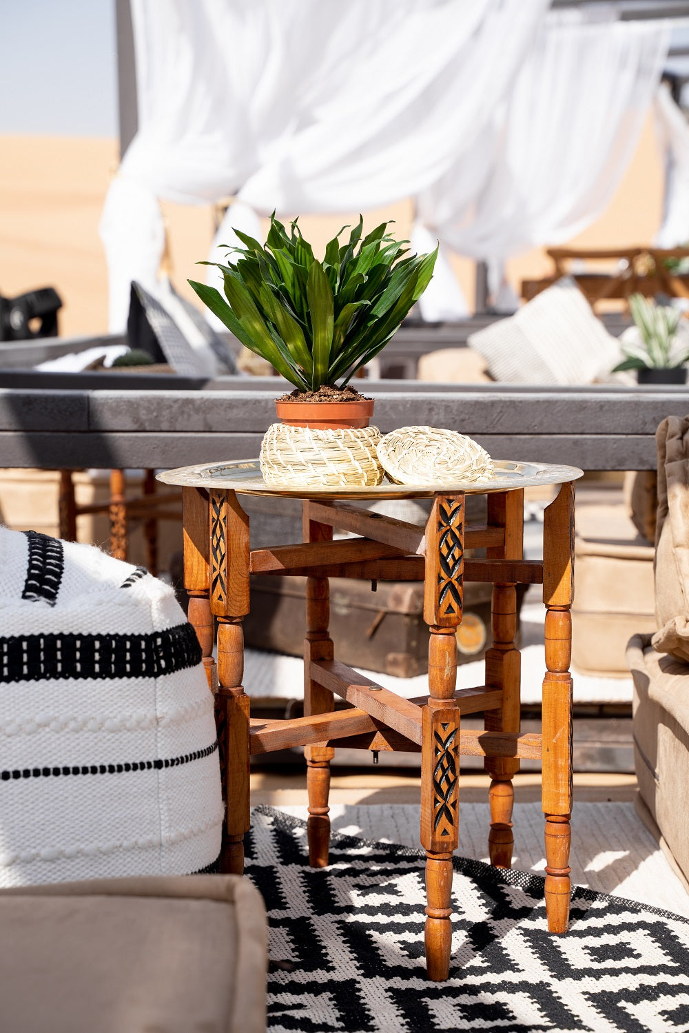 Moroccan folding table with intricate geometric patterns and vibrant colors. The table features a collapsible design for easy storage and transport, with ornate detailing typical of Moroccan craftsmanship.