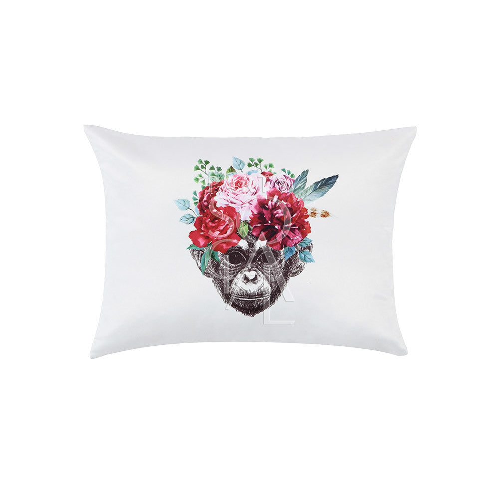 Off-white cushion featuring a playful monkey face print in the center.