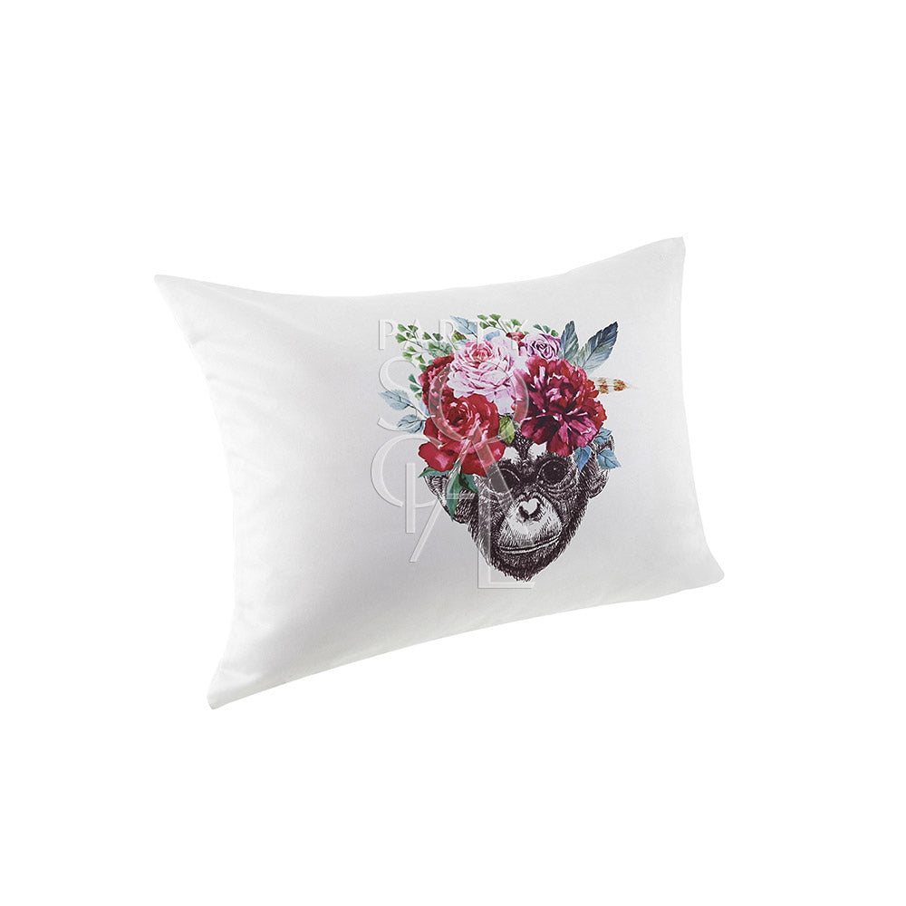 Off-white cushion featuring a playful monkey face print in the center.