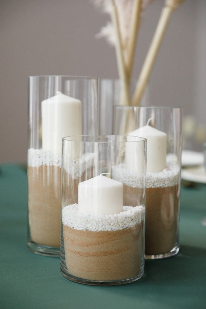 Elegant cylinder glass vases with a simple, clear design, featuring a smooth, cylindrical shape. These vases are ideal for displaying flowers or decorative accents, adding a touch of modern sophistication to any setting.