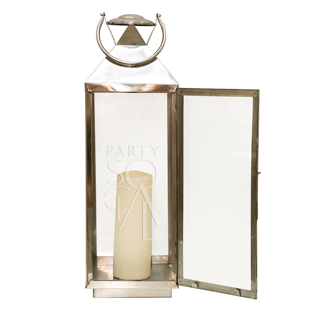 Elegant silver lanterns with a sleek, metallic finish and intricate detailing. The lanterns feature a classic design that adds a touch of sophistication and charm, perfect for illuminating and enhancing any indoor or outdoor setting.