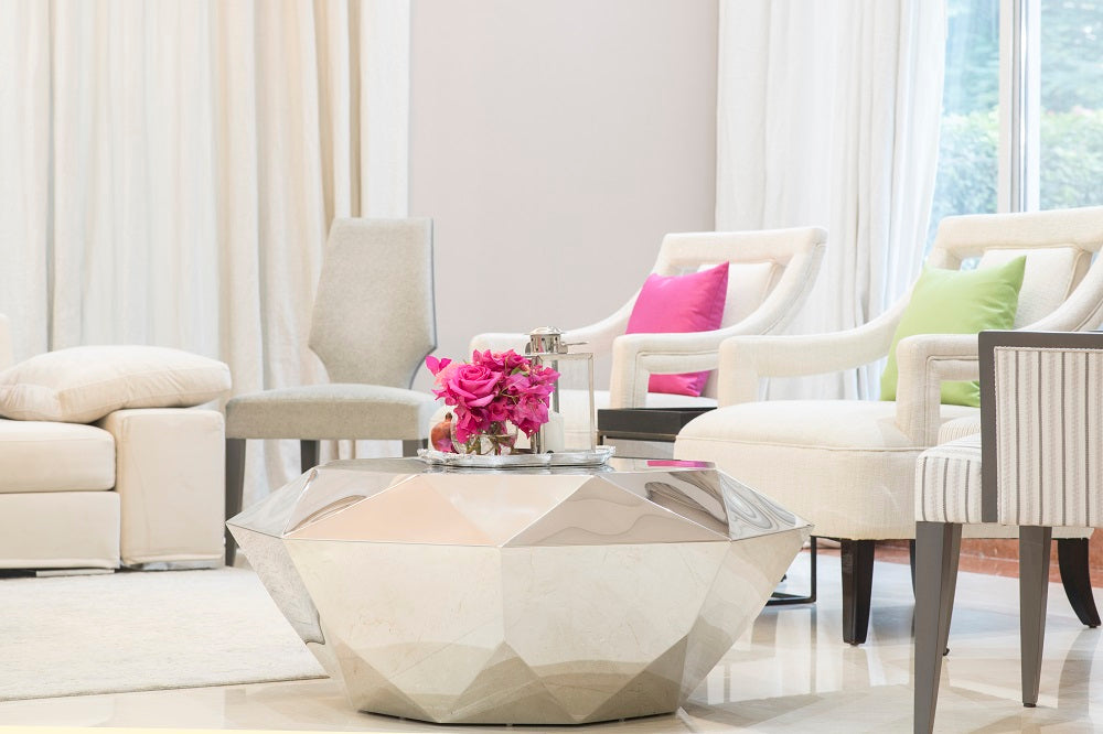 Elegant mirrored silver coffee table with a reflective surface and sleek metallic finish, adding a touch of glamour and sophistication to any living room or lounge area.