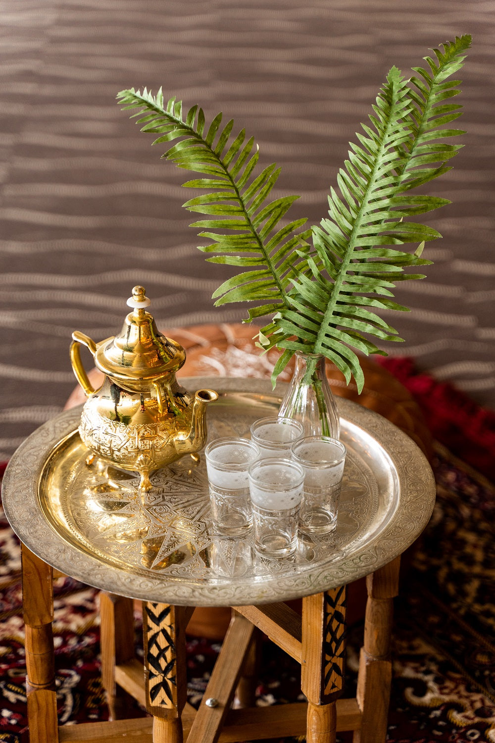 Moroccan tea glasses with intricate designs, ideal for traditional tea service.