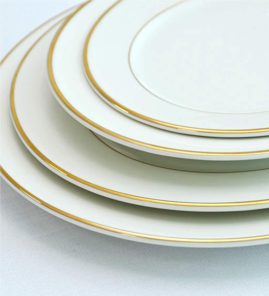 Modern china plate with a refined gold rim, featuring a sleek and contemporary design that adds an elegant touch to any dining occasion.
