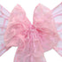 Delicate sheer organza chair sash in pink, featuring a lightweight, translucent fabric with a soft, shimmering finish. The pink color adds a charming and feminine touch, perfect for enhancing any event with a touch of sweetness.