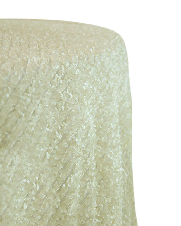 Round tablecloth with a textured fabric, featuring a subtle and elegant pattern that adds depth and interest. The textured design enhances the table setting with a sophisticated and stylish touch, ideal for both casual and formal occasions.