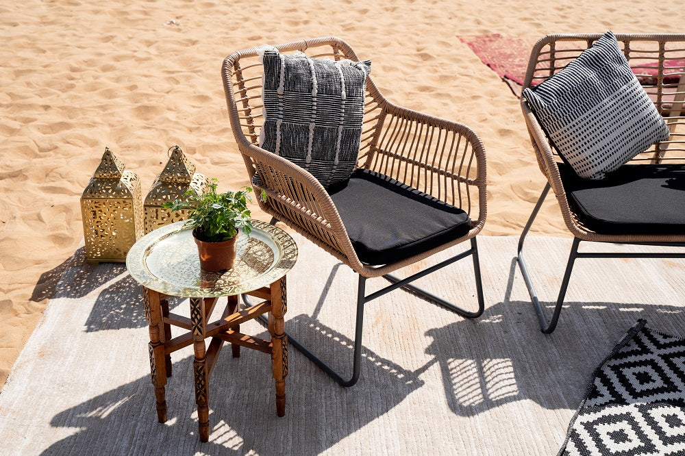 Charming rattan coffee table featuring a natural woven rattan base with a sleek, transparent glass top. The table’s elegant design combines the texture of rattan with the sophistication of glass, making it a stylish and functional centerpiece for living rooms or outdoor spaces.
