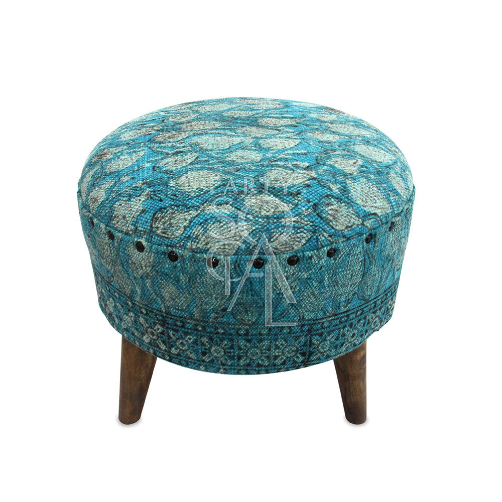 Compact low stool with a minimalist design, featuring a sturdy wooden frame and a cushioned seat covered in a durable fabric. The stool’s low height makes it ideal for casual seating or as a footrest in modern interiors. Its simple, elegant appearance complements various decor styles.