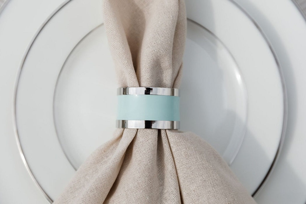 Elegant round napkin ring in silver and aqua, featuring a sleek silver finish with a striking aqua accent. The combination of colors and the polished design add a sophisticated and modern touch to any table setting.