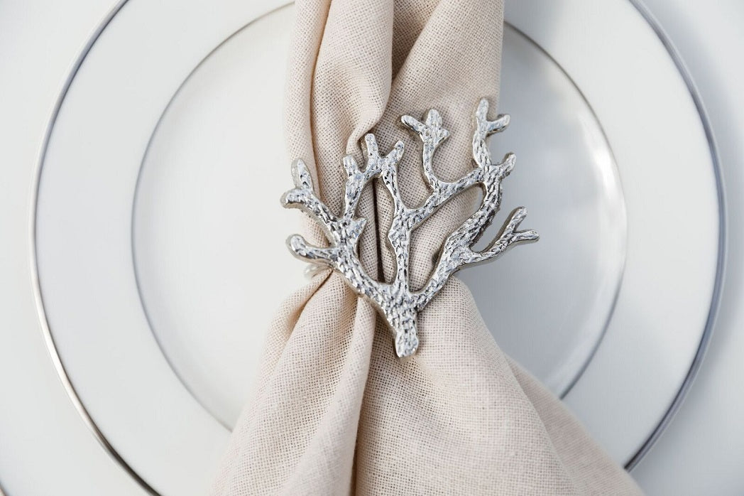 Stylish napkin ring in silver, designed with an intricate coral motif. The detailed coral pattern adds a touch of coastal elegance and sophistication, making it a unique and eye-catching accent for any table setting.
