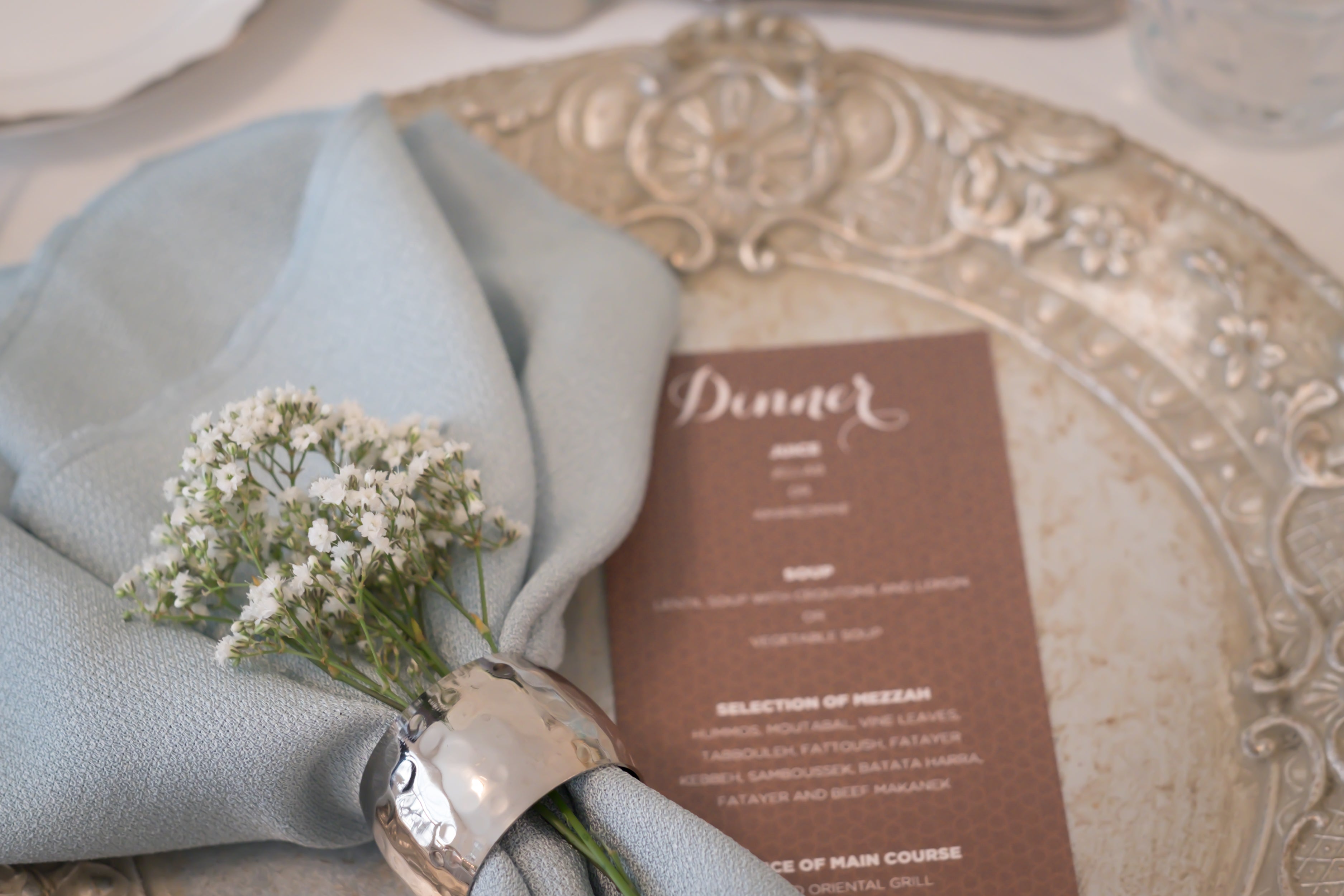 Napkin ring with a hammered dome design, featuring a textured surface for a stylish and contemporary look.