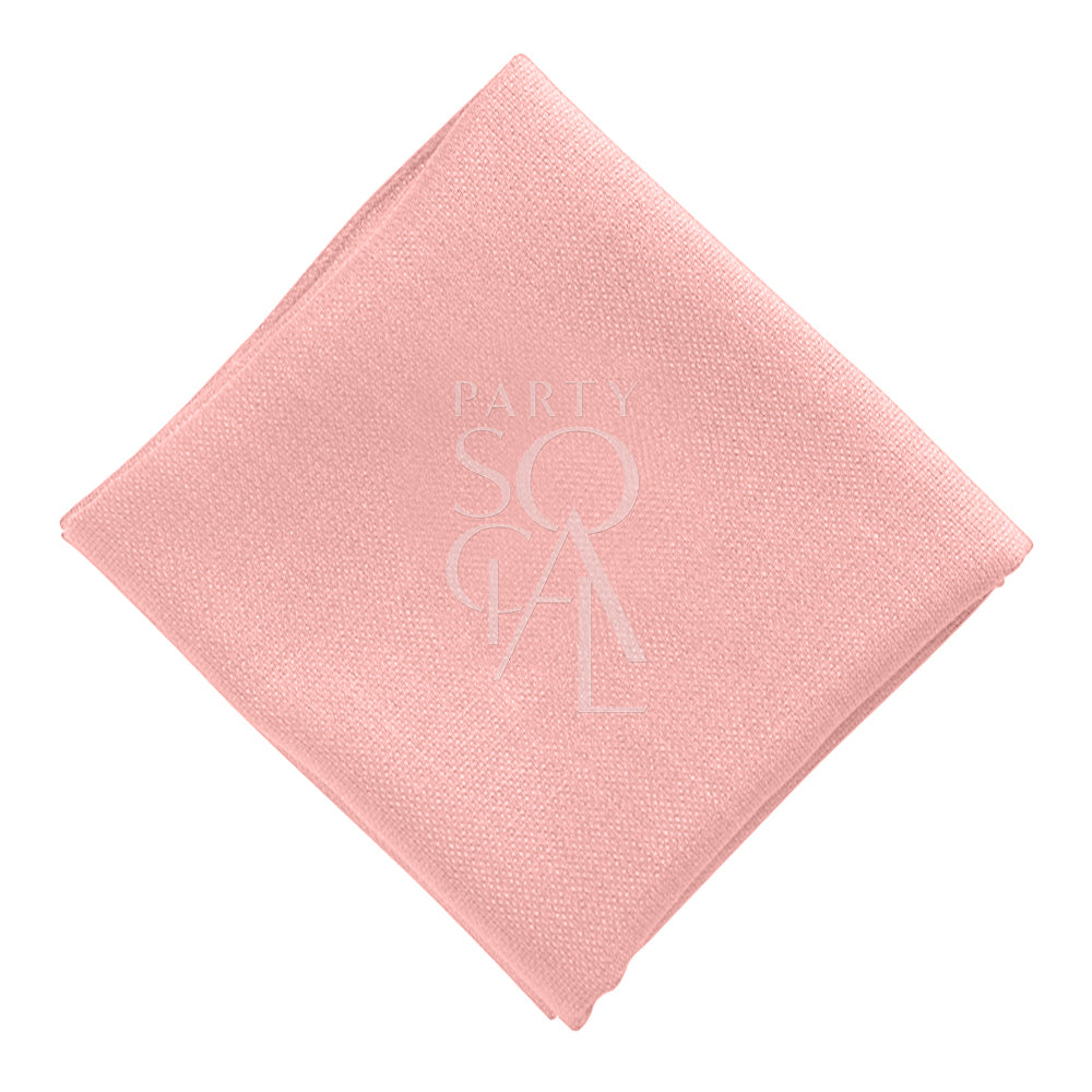 Soft cotton linen napkin in a delicate blush pink hue, featuring a smooth, refined texture. The gentle pink color adds a subtle touch of elegance to any table setting or event.