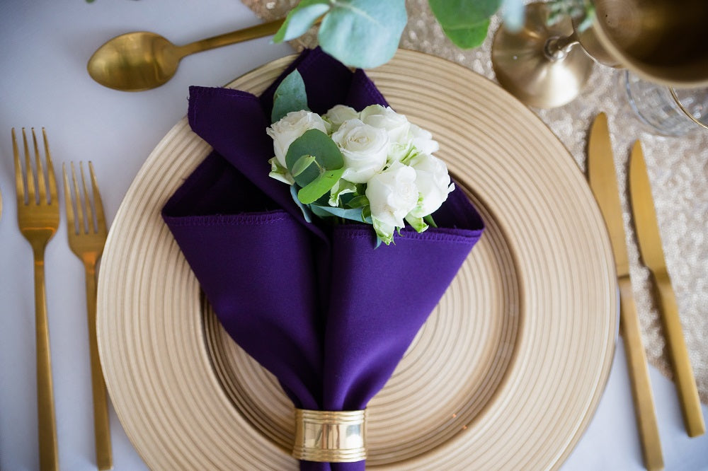 Gold-rimmed glass in a deep aubergine hue, featuring a luxurious gold trim around the rim. The rich aubergine color adds a touch of sophistication and elegance, perfect for a refined and upscale table setting.