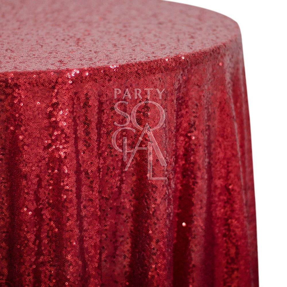 Round sequin tablecloth in vibrant red, featuring a bold and dazzling surface. The red sequins add an energetic and glamorous touch, perfect for making a statement at any festive or special occasion.
