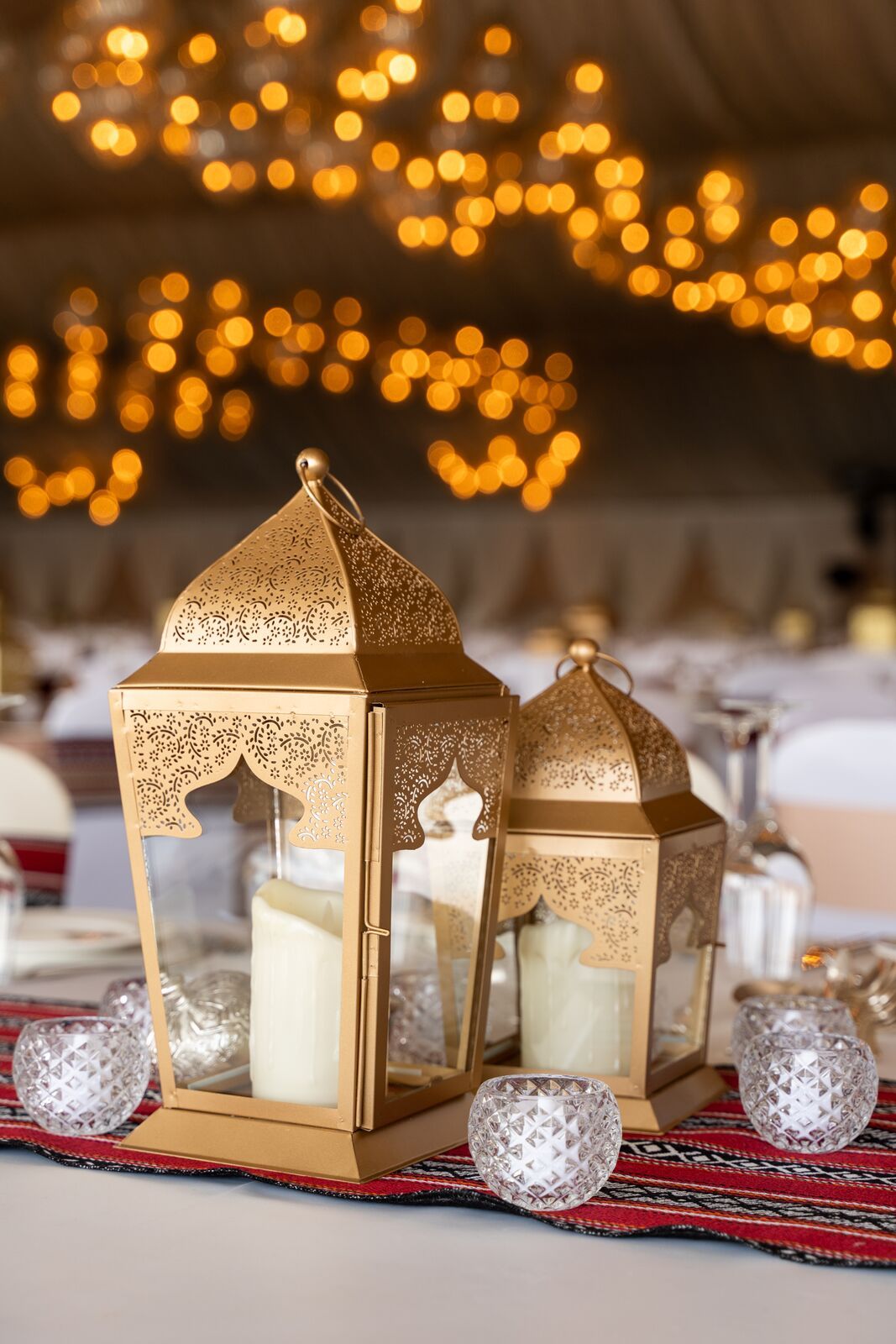 Chic rose gold lanterns with a modern metallic finish, featuring delicate cut-out patterns that cast beautiful light patterns. The lanterns add a touch of warmth and elegance, perfect for enhancing the ambiance of any space with a contemporary flair.